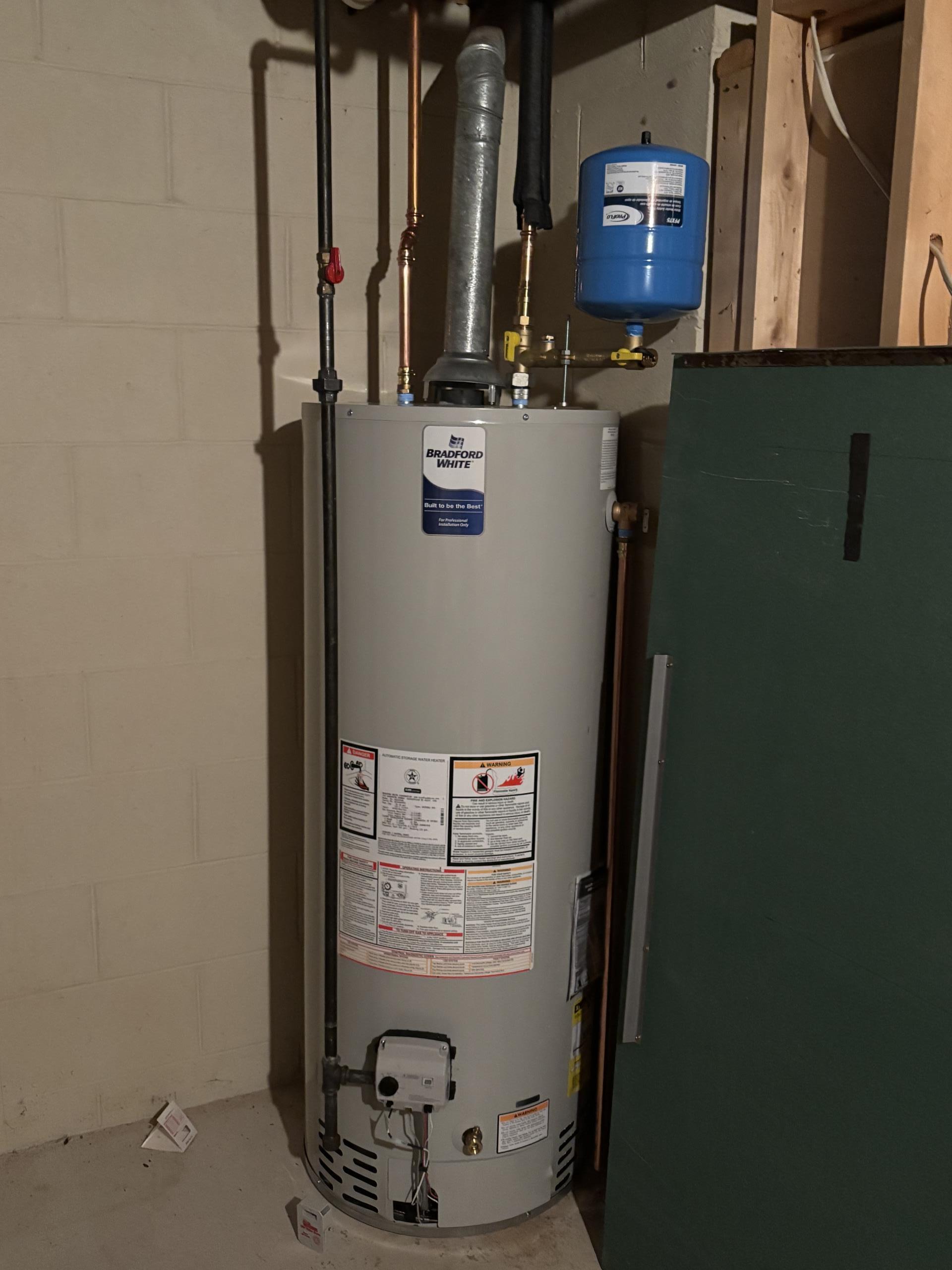 Removal and disposal of the existing brine tank and the softener. Connect the existing 1” copper cold main to the section of pipe to remove the softener. Provide and install a 50 gallon chimney vented water heater. Replaced the 1” main valve after the meter.