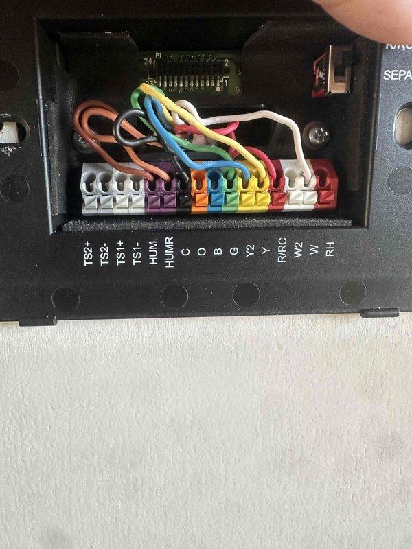 Successfully relocated two thermostats in the pickleball cottage per client's (Eric) request, moving them from their original position to the adjacent wall where the alarm panel is located. All connections were properly terminated and system operation was verified after relocation.