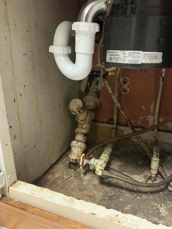 Diagnosed and cleared clogged kitchen sink drain line where disposal was backing up into sink when activated. Discovered significant mineral buildup and corrosion in older metal pipes connected to the P-trap. Recommended hydro-jetting service to address severe blockage and prevent recurrence.