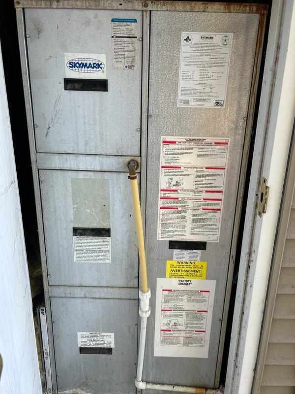 Diagnosed air conditioning system that failed to operate or blow air. Found refrigerant charge low and identified previous repairs to inducer motor and blower motor capacitor. Confirmed active refrigerant leak requiring repair; recommended service options to homeowner who is preparing property for sale.