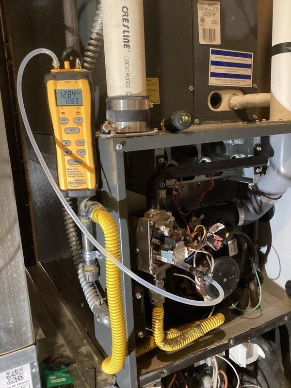 Performed scheduled furnace tune-up on 9-year-old unit per maintenance agreement. Replaced dirty filter (customer-supplied), cleaned condensate system, and removed soot buildup from burners that initially prevented proper ignition. Noted significant burner corrosion and concerning areas on heat exchanger first bends, though no visible cracks were detected. After service, furnace operated properly with correct temperature rise, but recommended heat exchanger replacement evaluation and system upgrade pricing due to orange flame appearance and soot accumulation in exhaust.