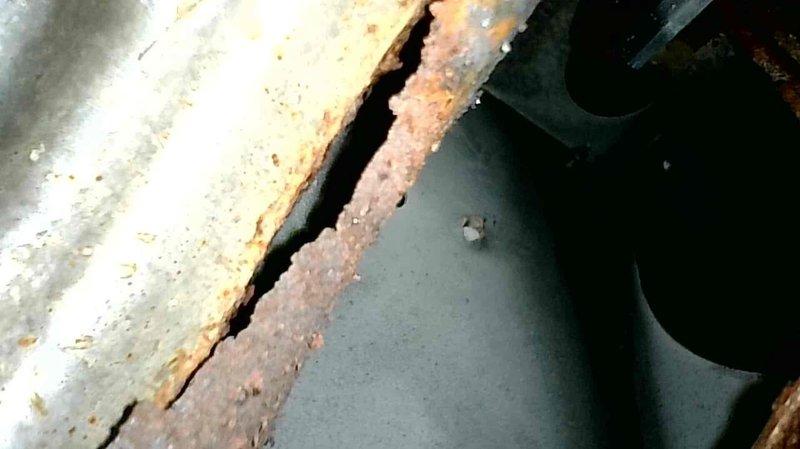 Responded to service call for an A/C system that wasn't running properly with fan continuously operating. Determined roll out switch was tripped, causing the continuous fan operation and preventing cooling function. Reset roll out switch which immediately restored normal A/C operation. Inspection with camera revealed separations in two burner inlets creating oxygen leaks, causing excessive combustion issues and soot buildup. Heat exchanger showed significant corrosion with visible cracks. Unit was tagged for safety and customer was informed about necessary heat exchanger replacement.