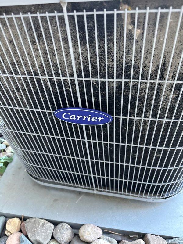 Diagnosed and resolved no cooling issue on a 5-year-old Carrier A/C unit. System had fan operation but no compressor function due to an out-of-specification capacitor. Replaced capacitor, restoring proper cooling function with amperage readings within normal parameters.