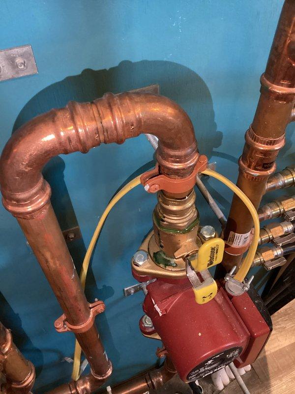 Responded to low pressure code on IBC boiler system. Determined autofill valve was turned off and pressure setting was too low. Restored proper operation by opening valves and adjusting autofill pressure. Noted minor leak issues at ball valve and pump flange connection requiring future attention.