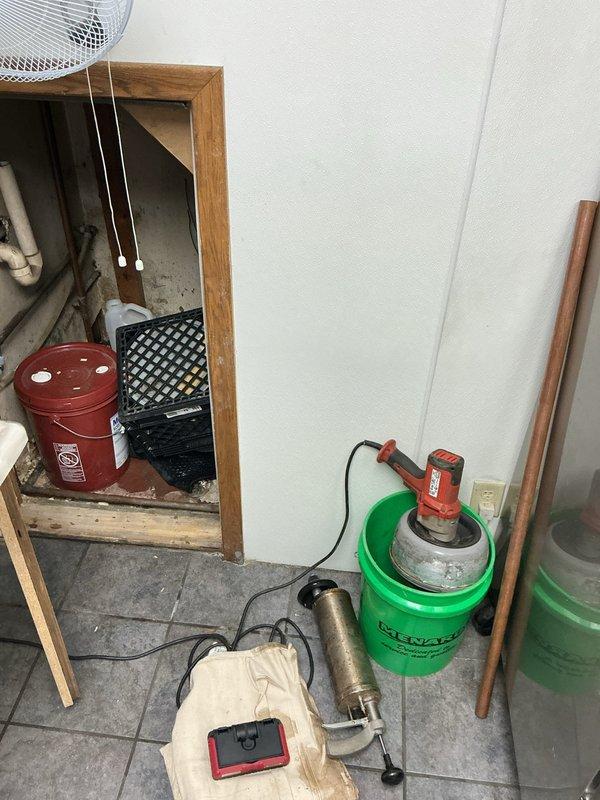 Completed site visit to estimate installation of customer-supplied commercial produce sink. Discovered installation challenges including lack of accessible drainage and water supply lines, with only limited access through tight quarters behind wall. Documented existing space and utility access points to develop comprehensive installation plan.