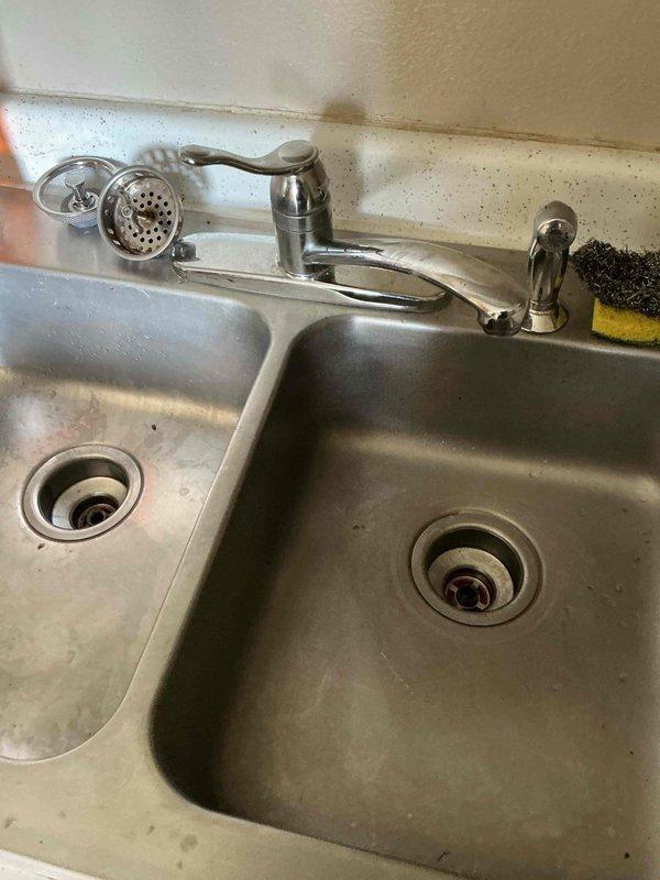 Cleared kitchen sink drain clog approximately 6 feet into the wall using an auger. Clog appeared to be grease-related, causing extremely slow drainage. Advised tenant on preventative maintenance to run hot water after washing dishes to minimize future grease buildup.