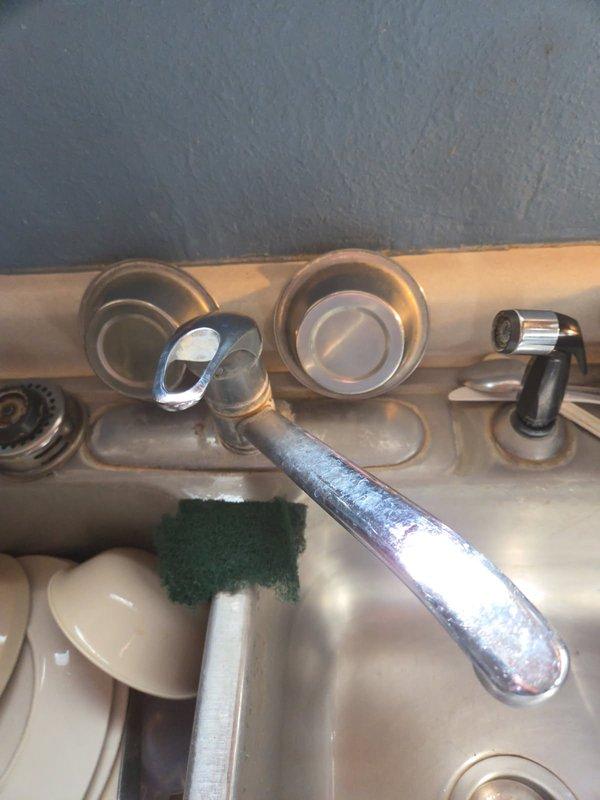 Conducted diagnostic assessment of leaking bathroom tub faucet and binding kitchen faucet. Removed kitchen faucet handle to evaluate internal mechanism and inspected bathtub drain assembly and spout connection. Provided customer with replacement options for both fixtures, noting the bathroom repair would require removal of the Lazy Susan and cutting access through the back for proper installation. Customer will review estimates and schedule installation service at a later date.