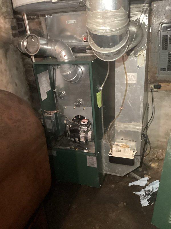 Performed standard maintenance on 2-year-old oil furnace including nozzle replacement, chimney inspection, and heat exchanger inspection. Discovered significant water accumulation in blower compartment, likely due to improperly sloped evaporator coil within the plenum from recent AC installation. Scheduled follow-up with installation supervisor to assess corrective measures needed.