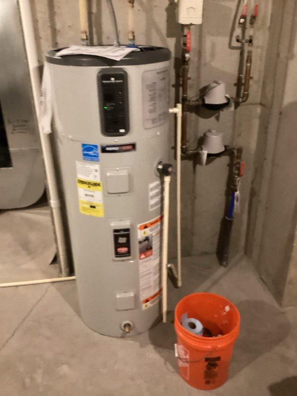 Responded to service call for Bradford White heat pump water heater displaying F20 error code. Diagnosed issue as clogged condensation pipe, which was removed, cleared of blockage, and drained of accumulated water. After thoroughly blowing out the obstruction in the pipe, reinstalled condensate line and verified proper system operation.