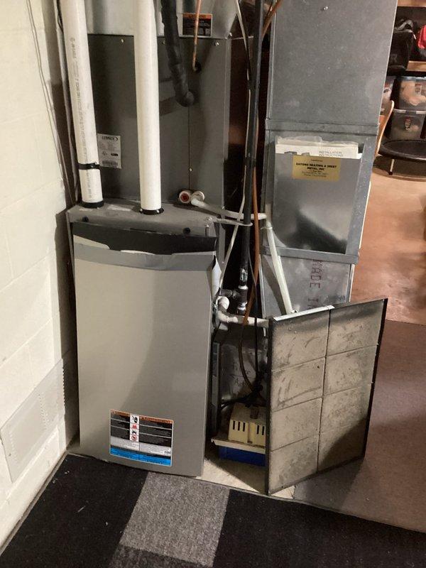 Performed comprehensive furnace tune-up on 14-year-old unit, including cleaning flame sensor and clearing condensate drainage system. Inspected heat exchanger (condition good), adjusted gas pressure settings for optimal performance, and verified proper system operation. Advised homeowner about dirty air filter requiring replacement.