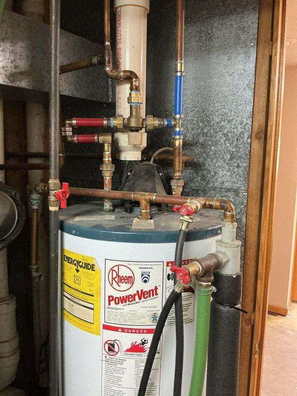 Provided estimate for replacement of 30-year-old 50-gallon LP power-vented water heater. Inspected current Rheem PowerVent system with complex copper/PVC piping configuration and evaluated feasibility of separating wood boiler from existing water heater and furnace. Service advisor scheduled for Friday to deliver formal bid.