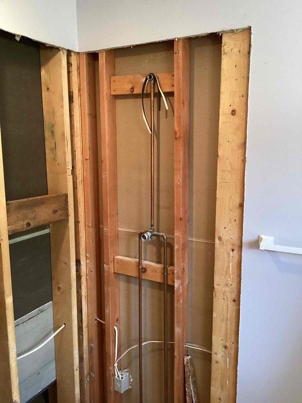 Performed site assessment for shower installation, which included evaluating existing drain connection and wall framing. Inspected plumbing rough-in to determine required modifications for new shower pan and valve installation. Reviewed manufacturer specifications and clearance requirements to ensure proper fit of proposed fixtures within the existing space.