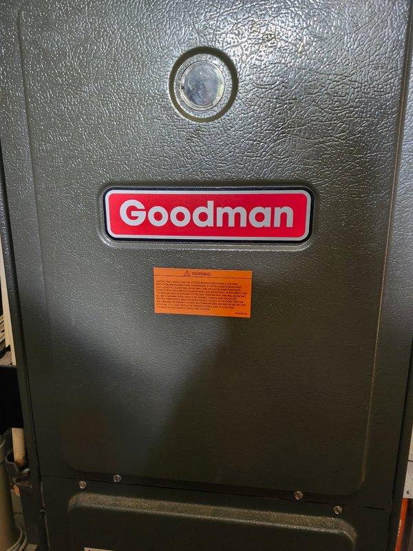 Responded to no heat complaint with diagnostic testing revealing pressure switch code on Goodman furnace. Discovered inoperable inducer motor receiving no power from control board, compromised heat exchanger seal with visible hole, and blower motor leaking oil with excessive dust accumulation. System was tagged out as unsafe to operate and replacement options were presented to customer including new heat exchanger, blower motor, and control board.