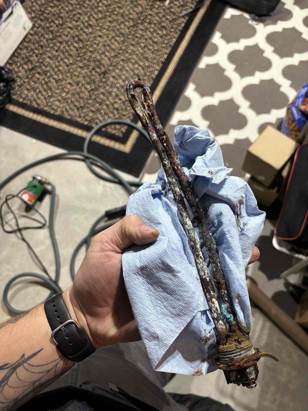 Replaced undersized lower heating element on 100-gallon Westinghouse electric water heater that had failed catastrophically due to extensive corrosion. The original element had deteriorated to the point of complete failure, causing insufficient hot water supply. Installed properly sized replacement heating element to restore normal hot water function under warranty service.