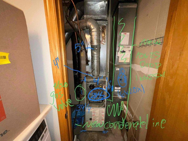 Conducted an HVAC system assessment after customer reported AC freeze-up issue. Inspection revealed aging furnace unit with compromised ductwork connections and condensate line problems. Recommended full system replacement based on observed component deterioration, improper installation markings, and ventilation concerns that are likely contributing to the cooling malfunction.