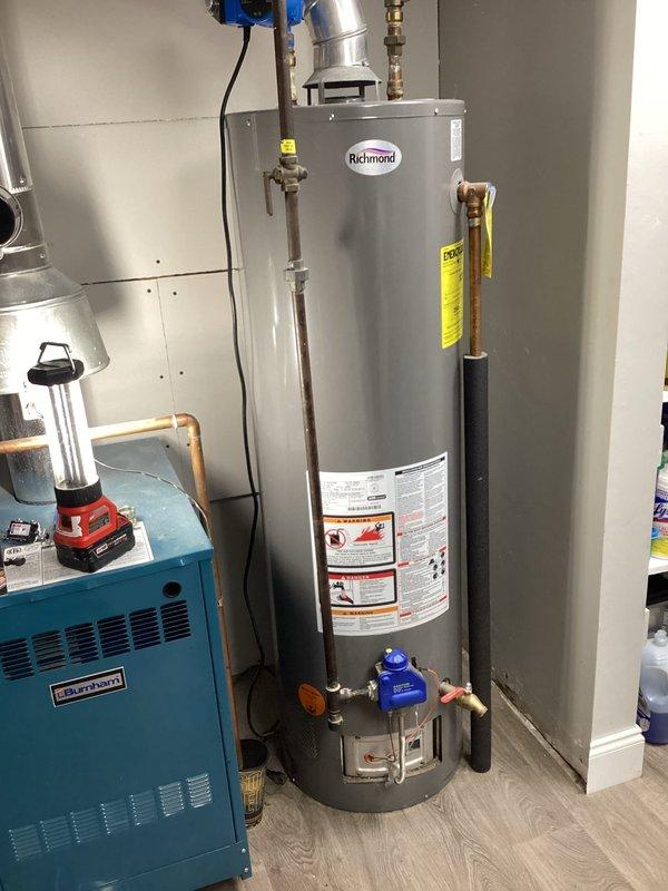 Responded to service call for Richmond water heater with pilot light outage resulting in no hot water. Diagnosed issue with pilot assembly, relit pilot light and verified proper operation. Provided customer with both repair and replacement options for their aging tank-style water heater, noting the Lennox heating system in proximity was functioning normally.
