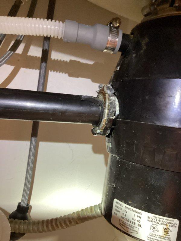 Removed and replaced a rusted garbage disposal that was jammed with coffee beans, which had caused sink drainage failure and standing water in dishwasher. Completed system reconnection and verified proper drainage with no leaks detected after installation.