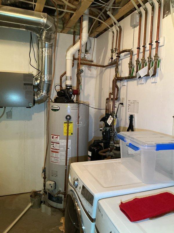 Inspected a leaking 75-gallon natural gas power vented water heater. Found 95 psi water pressure and a leaking main line requiring attention. Documented existing installation, including the A.O. Smith unit, copper piping network, and venting system. Recommended complete replacement of the water heater and main line rebuild to resolve multiple failure points.