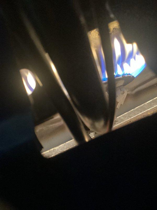 Performed routine LP furnace tune-up on 10-15 year old system. Inspection revealed critical safety issues including cracked heat exchanger with visible holes in side. Unit was tagged out of service due to safety concerns. Service advisor dispatched to discuss replacement options with customer.