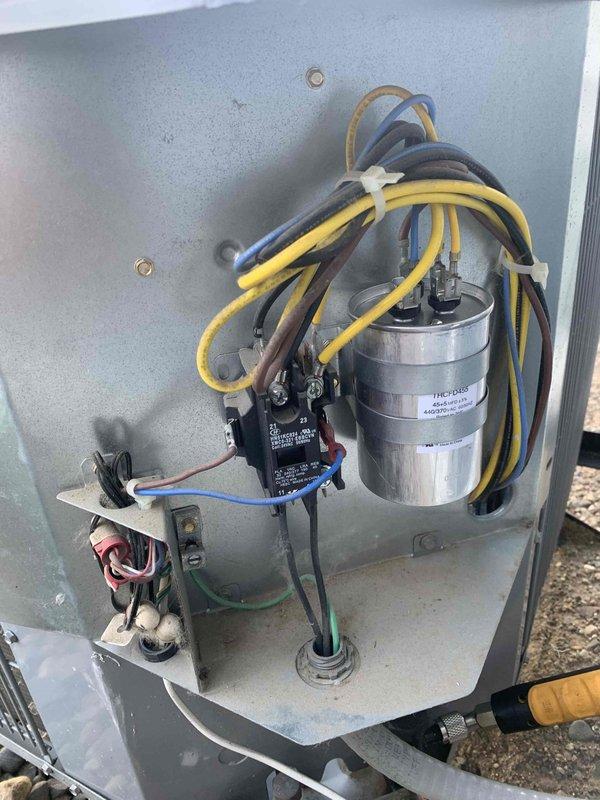 Responded to no-cool complaint for 7-8 year old AC system with tripped breaker. Diagnostic testing revealed a drained capacitor on fan side while compressor tested good. Replaced defective capacitor, reset breaker, and verified proper system operation by checking refrigerant levels, wiring, and coil. System restored to normal cooling function.