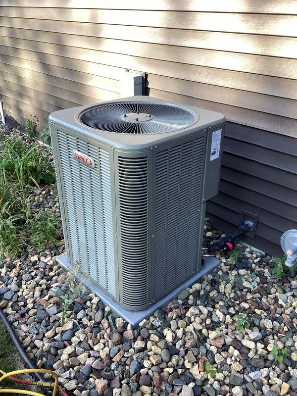 Diagnosed 3-month-old Lennox A/C unit with no cooling due to severe refrigerant leak in condenser coil. System was charged temporarily to restore cooling while warranty replacement is arranged. Documentation confirms unit was delivered without proper factory charge, requiring sales management follow-up for complete unit replacement.