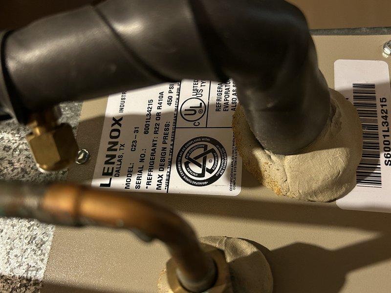 Diagnosed AC system not cooling with customer complaint of warm air and non-functioning outdoor fan. Inspection revealed failed condenser fan motor and damaged capacitor. Performed electrical testing confirming proper voltage to motor. Noted secondary issue with furnace showing signs of inducer gasket failure and leakage. Heat exchanger inspection indicated dirty blower wheel and low igniter resistance (16 ohms). Service advisor scheduled for follow-up to address repair options.