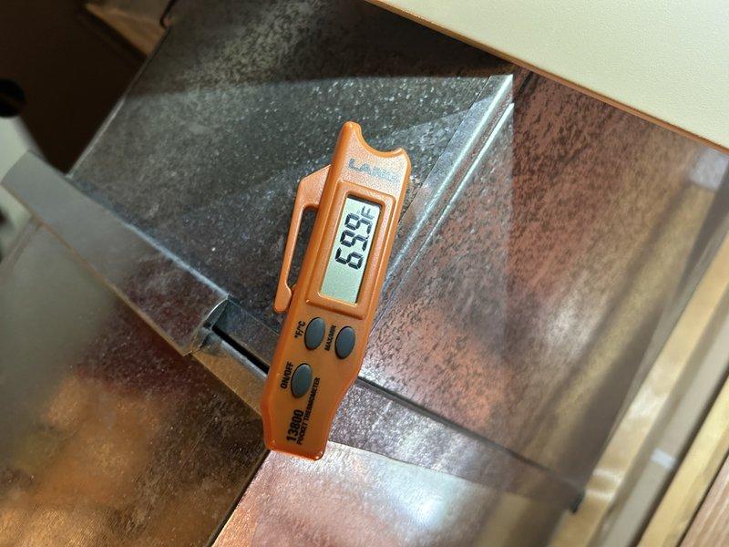 Diagnosed AC system not cooling with customer complaint of warm air and non-functioning outdoor fan. Inspection revealed failed condenser fan motor and damaged capacitor. Performed electrical testing confirming proper voltage to motor. Noted secondary issue with furnace showing signs of inducer gasket failure and leakage. Heat exchanger inspection indicated dirty blower wheel and low igniter resistance (16 ohms). Service advisor scheduled for follow-up to address repair options.