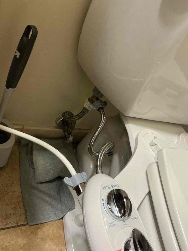 Diagnosed and repaired a water leak from bathroom sink that was causing water to accumulate on the floor. Inspection revealed faulty supply line connections to the bidet attachment. Replaced worn braided stainless steel supply lines and properly secured all plumbing connections to resolve the leak issue.