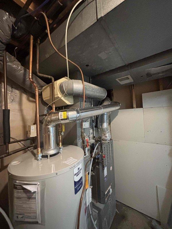 Diagnosed tank-type water heater failure with leakage onto the burner assembly, causing repeated shutoff after restart attempts. Visual inspection confirmed water damage to heating components. Complete unit replacement was performed to restore hot water service.