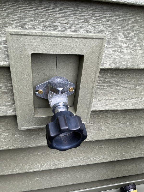 Completed exterior hose bib reinstallation following customer's home residing project. Two outdoor water spigots were properly secured and mounted to the vinyl siding using the appropriate recessed mounting boxes, ensuring proper alignment and secure attachment with mounting screws.