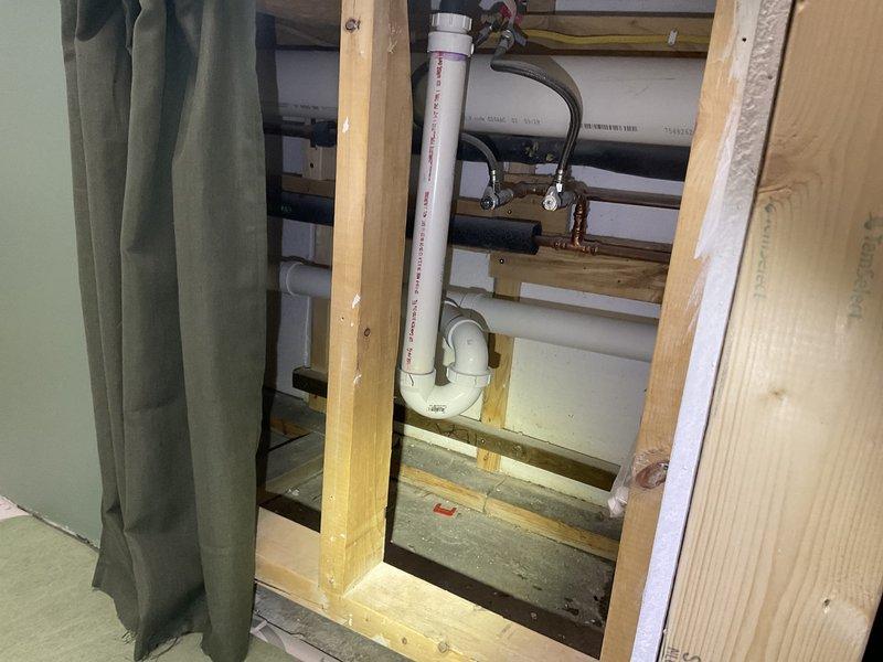 Investigated sewer gas odor in recently remodeled basement bathroom. Diagnostics revealed floor drain backup and gurgling when draining bathroom sink and utility sink. Installed 2" PVC wye with cleanout access and cleaned drain piping to eliminate cross-contamination and prevent sewer gas infiltration.