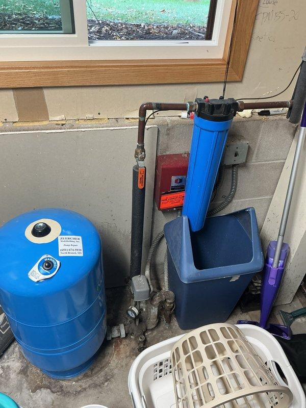 Conducted comprehensive plumbing inspection and performed water heater flush service as requested. Observed significant mineral buildup and sediment in the tank interior during flush procedure. Noted existing water filtration system with pressure tank in good working condition.