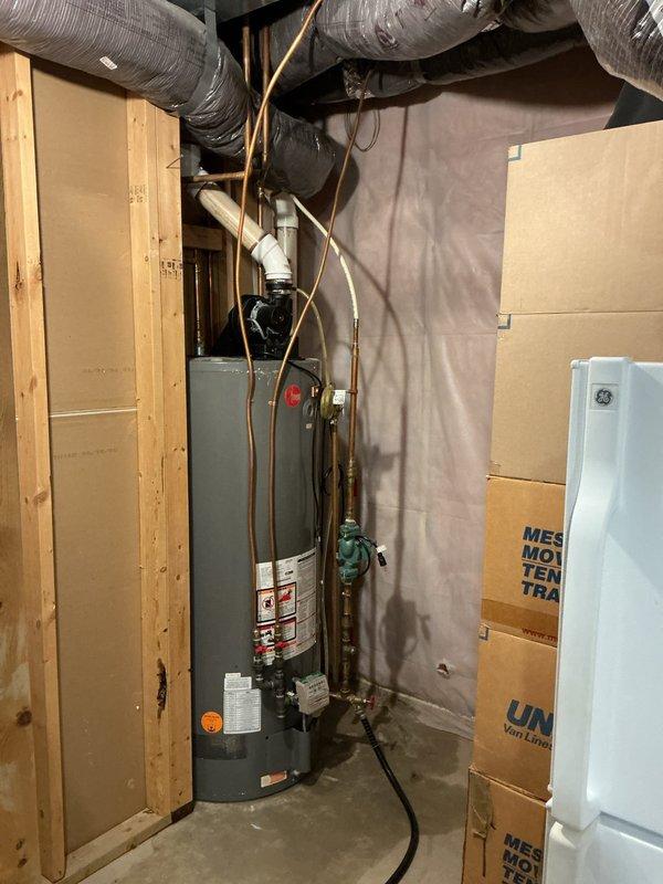 Diagnosed leaking 75-gallon power-vent water heater with no hot water output. Took measurements of clearance requirements for replacement unit and documented existing installation conditions. Recommended replacement water heater with expansion tank and coordination with HVAC technician regarding condenser relocation.