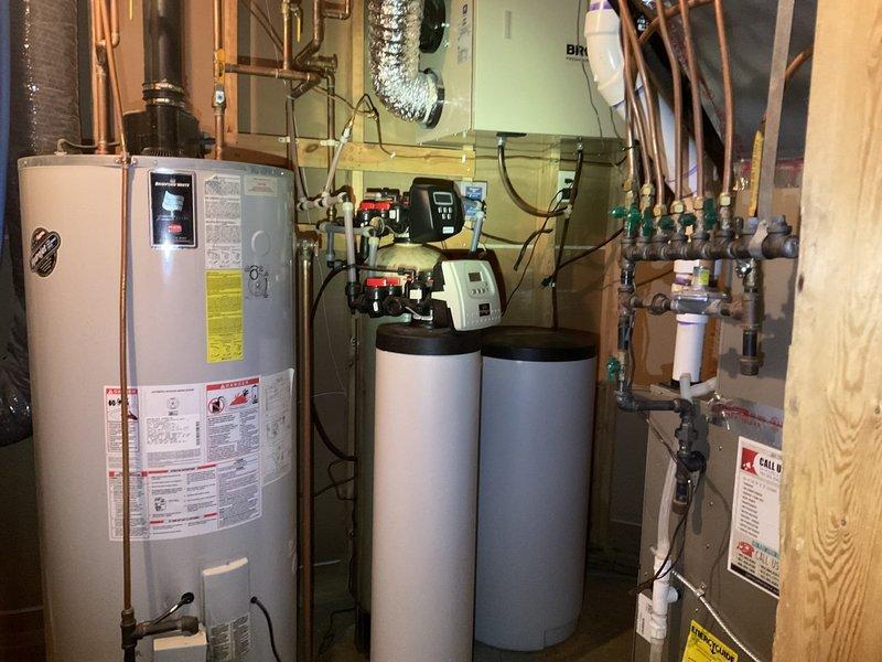 Performed comprehensive evaluation of water heating and treatment system. Inspected 75-gallon LP power vent water heater (2005 model) exhibiting signs of bottom leakage and diagnosed malfunctioning iron filtration system. Troubleshooted intermittent whistling issue with water softener related to tubing configuration. Provided customer with replacement options for both water heater and water treatment components.