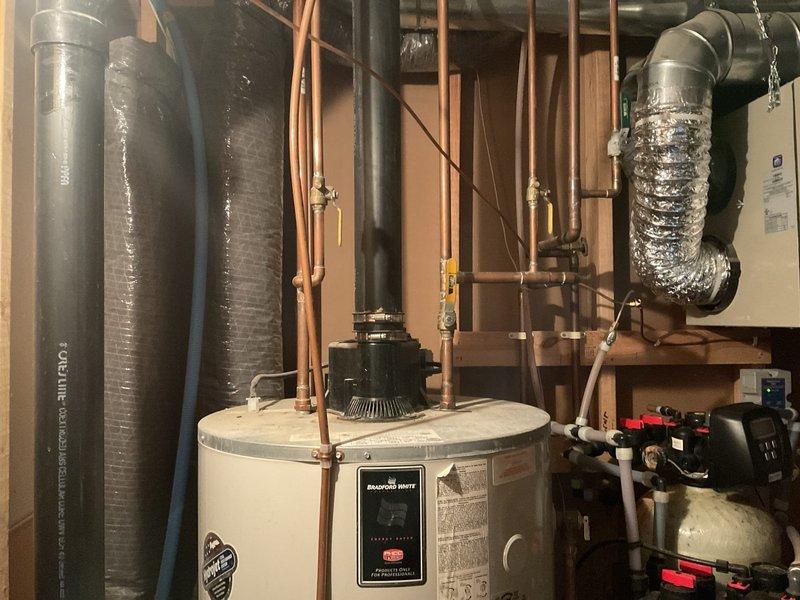Performed comprehensive evaluation of water heating and treatment system. Inspected 75-gallon LP power vent water heater (2005 model) exhibiting signs of bottom leakage and diagnosed malfunctioning iron filtration system. Troubleshooted intermittent whistling issue with water softener related to tubing configuration. Provided customer with replacement options for both water heater and water treatment components.
