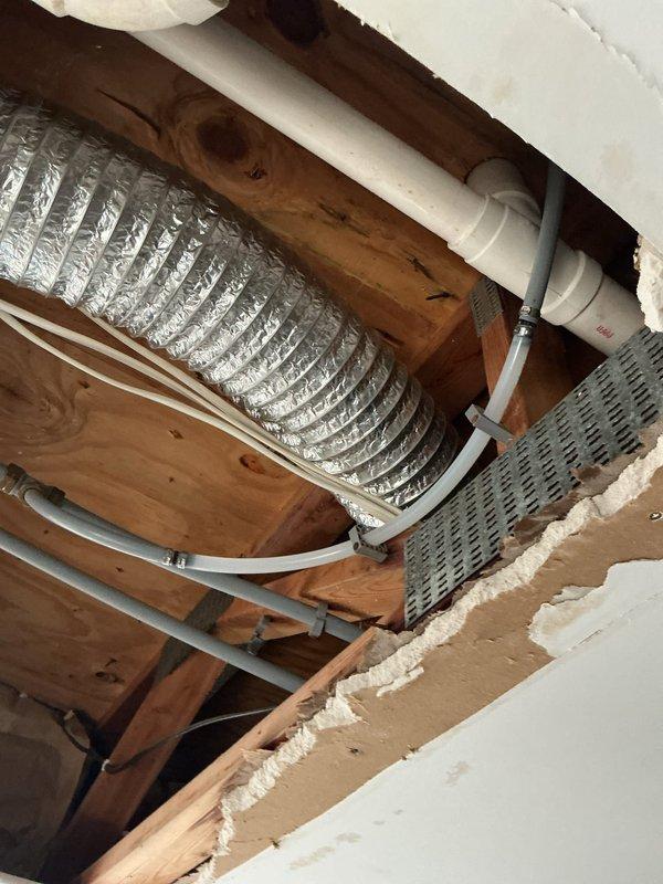 Responded to water leak service call where leak source had been previously identified by restoration company. Accessed damaged ceiling area exposing building infrastructure and repaired compromised section of 1/2" PEX supply line servicing toilet.