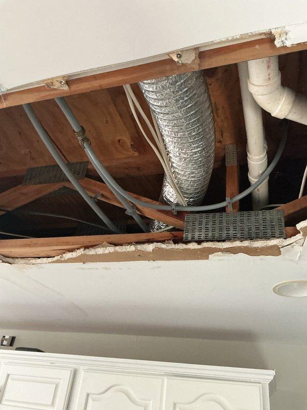 Responded to water leak service call where leak source had been previously identified by restoration company. Accessed damaged ceiling area exposing building infrastructure and repaired compromised section of 1/2" PEX supply line servicing toilet.