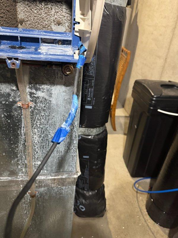 Diagnosed and repaired water leakage from humidifier by replacing damaged internal water line and worn humidifier pad. Performed system cycle test to verify proper operation, inspected furnace for water damage, examined heat exchanger and burners, and replaced customer-supplied air filter, restoring system to normal functioning condition.