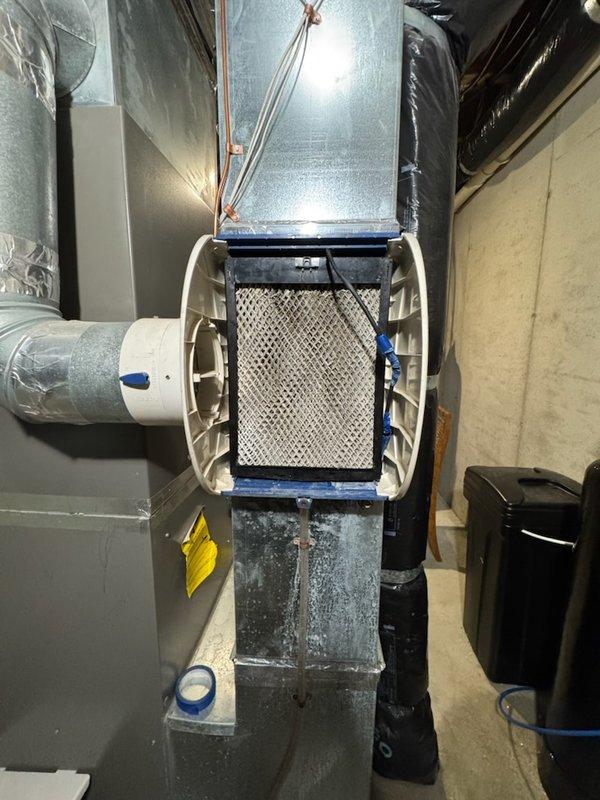 Diagnosed and repaired water leakage from humidifier by replacing damaged internal water line and worn humidifier pad. Performed system cycle test to verify proper operation, inspected furnace for water damage, examined heat exchanger and burners, and replaced customer-supplied air filter, restoring system to normal functioning condition.