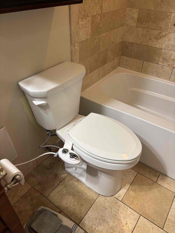 Completed installation of new ADA-compliant toilet with elongated bowl to replace customer's existing unit which had multiple failures including leaking tank-to-bowl gasket and worn fill valve causing continuous running. Installed complete toilet package with wax ring and mounting bolts, connected water supply lines, and ensured proper function of new fixture which provides improved performance while using less water.