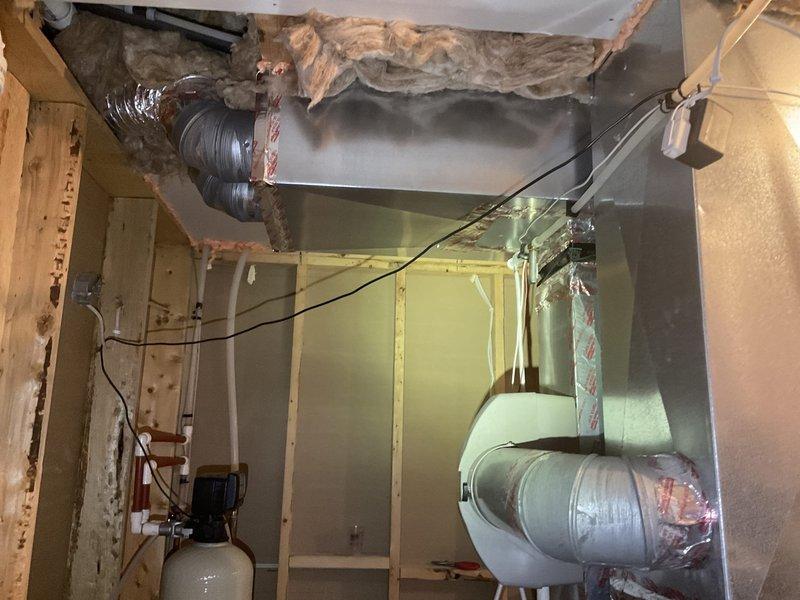 Performed water treatment system assessment for customer whose current water softener was failing and leaking (currently bypassed). Inspection of utility area revealed exposed plumbing infrastructure with existing water filtration components. Evaluated installation requirements considering current PVC piping configuration and meter setup in partially finished utility space. Provided comprehensive estimate for new water treatment system replacement.