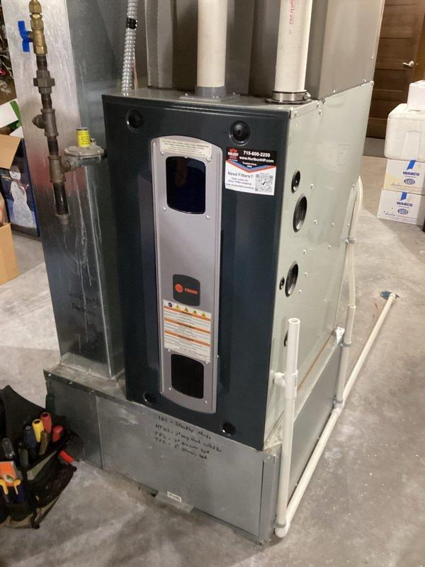 Responded to service call for inadequate airflow from 13-year-old furnace. Diagnosed system was functioning properly but operating in single-stage mode due to minimal temperature differential setting. Serviced washable air filter and educated homeowner on proper thermostat operation to achieve desired second-stage heating when needed.