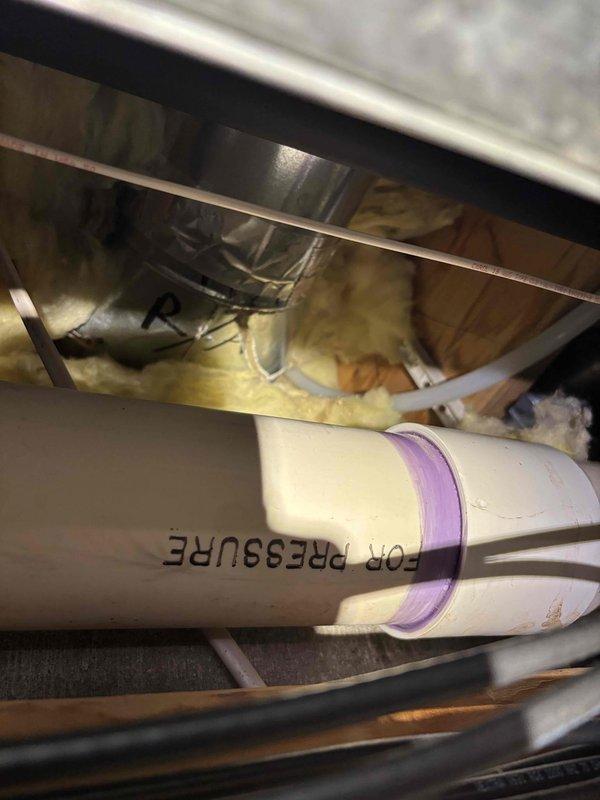 Disconnected dishwasher to facilitate flooring replacement following kitchen flood damage caused by ice maker line leak. Installed new water supply line for refrigerator ice maker with proper connection to prevent future leakage issues. Access required navigation through confined utility chase to properly route copper supply line.