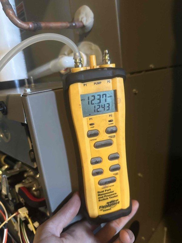 Completed gas pressure validation and adjustment following LP regulator replacement by gas company. Verified proper operation of newly installed secondary regulator and confirmed appropriate gas pressure settings for both high and low fire operation using dual port manometer.