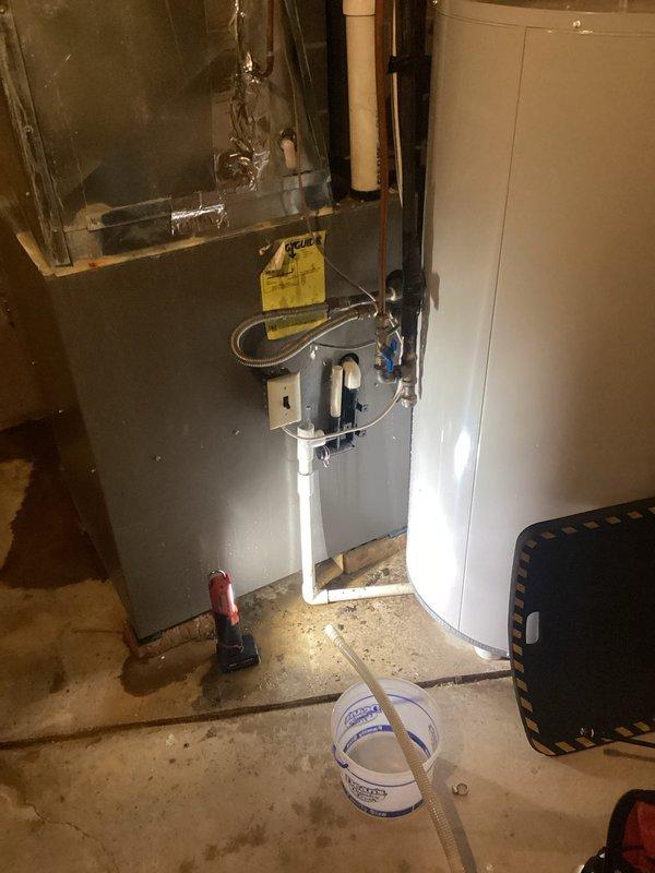 Responded to water leakage issue around 7-year-old furnace. Discovered completely clogged condensate drain line (2ft flexible tubing between drain pan and trap); removed and cleared the blockage to restore proper drainage. Tested AC operation for 20 minutes, confirming proper function with 20-degree temperature drop, and verified furnace operation. Recommended preventative maintenance tune-up to customer.