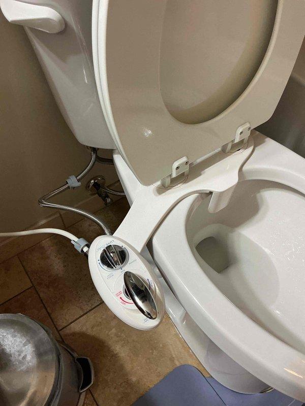 Responded to service call regarding a bidet attachment previously reinstalled with new toilet that was dripping from the nozzle. Visual inspection confirmed water leakage from the bidet nozzle connection point. Provided customer with quotation for replacement bidet unit as current one cannot be effectively repaired.
