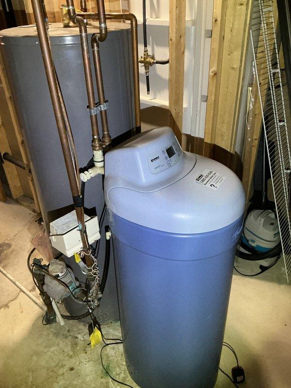 Responded to service call regarding non-operational water softener installed approximately two years prior but never activated. Upon inspection, determined the existing water softener unit was non-functional. Bypassed the system by looping the water lines and removed the defective softener from the premises, allowing uninterrupted water flow through the home's plumbing system.