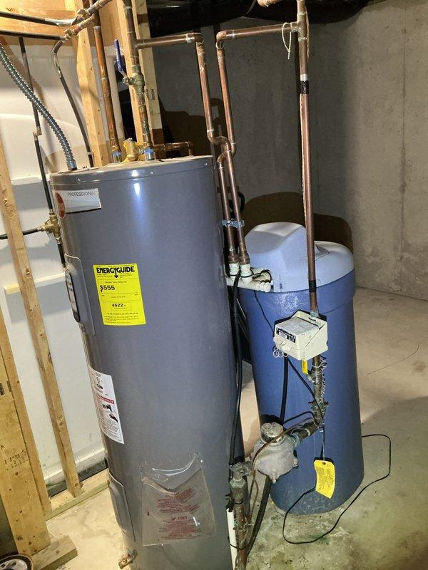 Responded to service call regarding non-operational water softener installed approximately two years prior but never activated. Upon inspection, determined the existing water softener unit was non-functional. Bypassed the system by looping the water lines and removed the defective softener from the premises, allowing uninterrupted water flow through the home's plumbing system.
