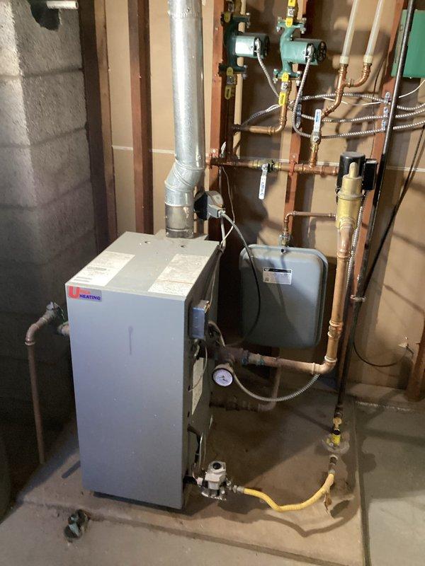 Completed installation of new iHEATING boiler system with associated copper piping, valves, and controls in basement utility room to replace existing unit. Extended and replaced fin tube baseboard heating elements in large room and bedroom following water damage remediation. System properly vented and connected to existing infrastructure with all necessary safety components installed per specifications.
