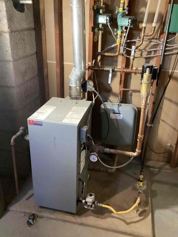 Completed installation of new iHEATING boiler system with associated copper piping, valves, and controls in basement utility room to replace existing unit. Extended and replaced fin tube baseboard heating elements in large room and bedroom following water damage remediation. System properly vented and connected to existing infrastructure with all necessary safety components installed per specifications.